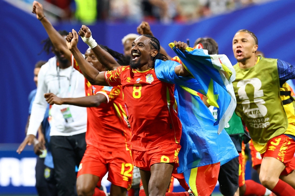  
DR Congo's Moutoussamy celebrates with their national flag . — Reuters   