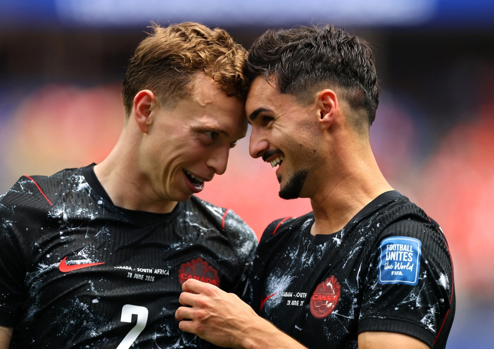  
Canada's Johnston and Eustaquio celebrate after the match. — Reuters