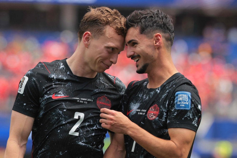  Canada's #02 Johnston (L) and #07 Eustaquio (R) celebrate the winning. — AFP 