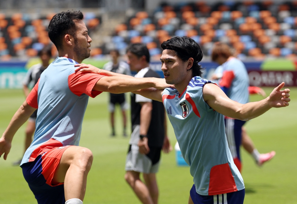  
Japan's Minamino and Yoshida during training. — Reuters 