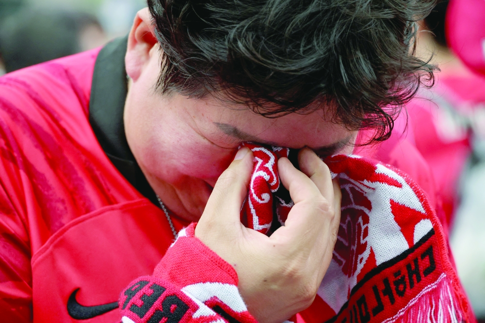 A South Korea fan looks dejected after the match. — Reuters