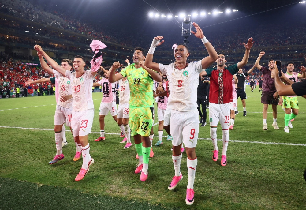 Morocco's Rahimi with teammates after the match. — Reuters