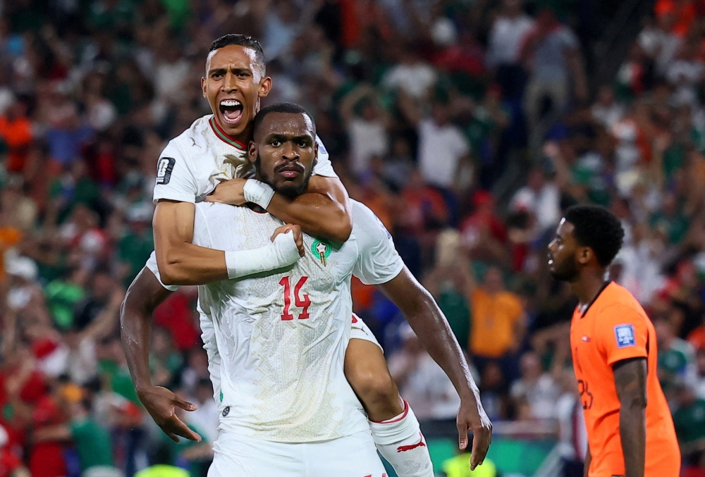  
Morocco's Diop celebrates scoring first goal with Rahimi. — Reuters       