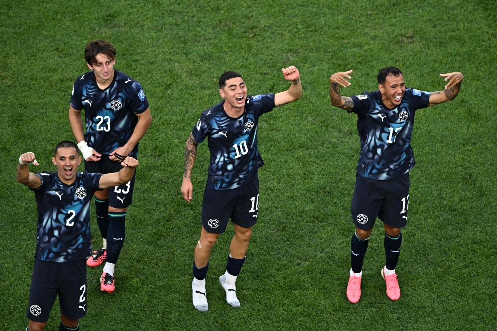 Paraguay's #02 Velazquez, #23 Galarza, #10 Almiron ,and #17 Gamarra celebrate the winning. — AFP
