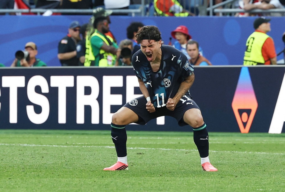  
Paraguay's Mauricio celebrates scoring a penalty. — Reuters