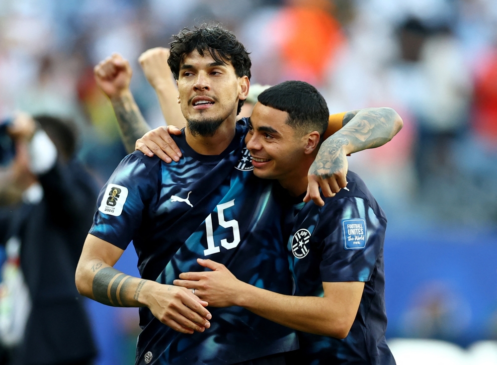  
Paraguay's Gomez and Almiron celebrate after the match. — Reuters
