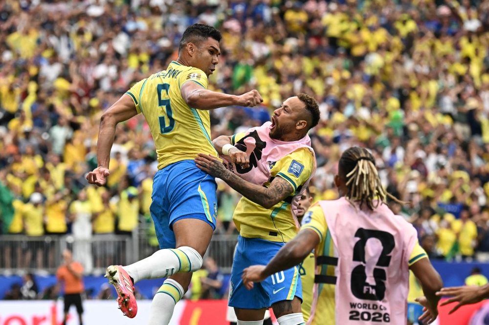 Brazil's #05 Casemiro (L) celebrates with Brazil's #10 Neymar. — AFP