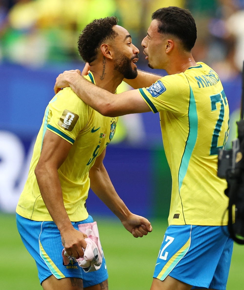  
Brazil's Cunha and Martinelli celebrate after the match. — Reuters 