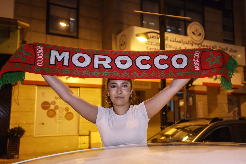 A football fan celebrates Morocco's victory over the Netherlands in the Round of 32 of the 2026 World Cup, in Rabat 