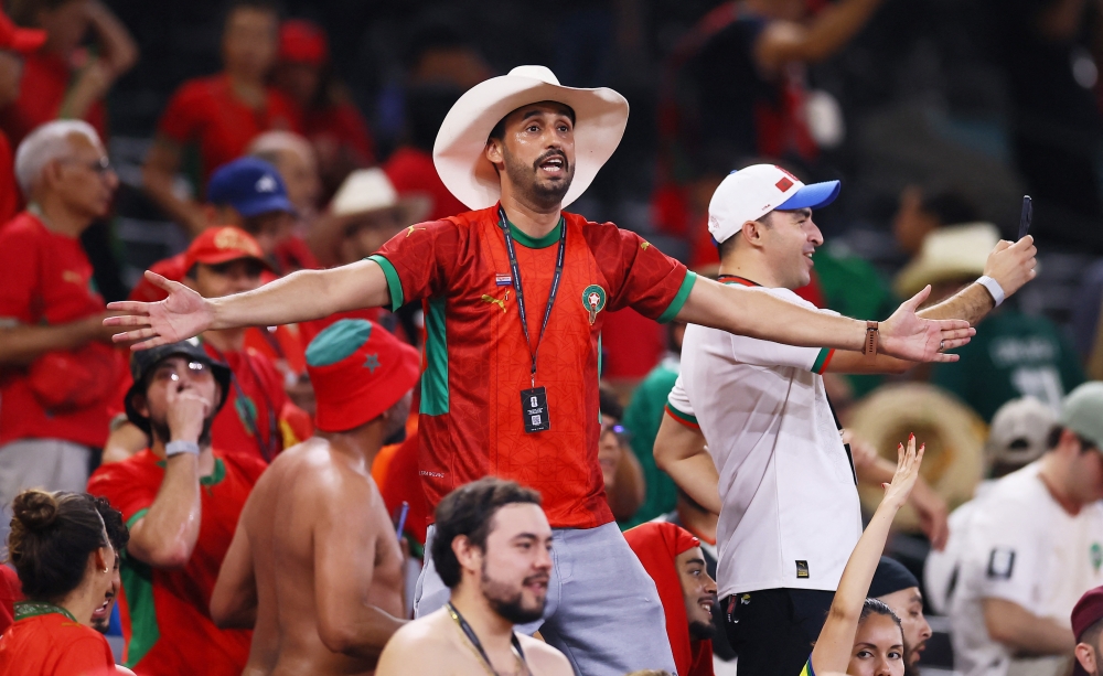  
Morocco fans celebrate after the match as Morocco qualify for the Round of 16  