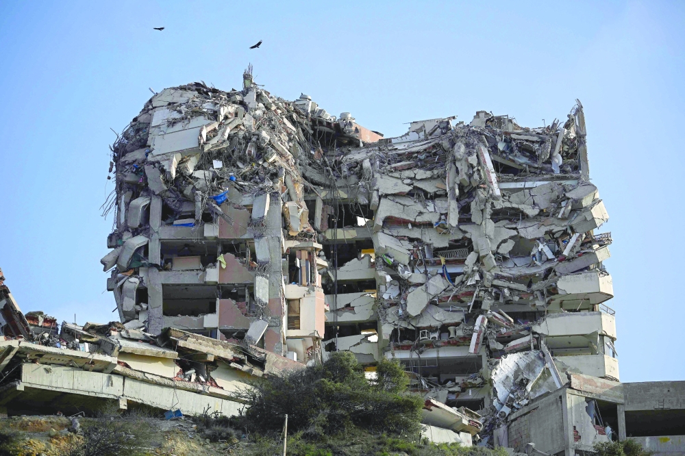 This view shows a heavily damaged multi-storey building with collapsed upper floors in the Playa Verde sector of Catia La Mar. — AFP