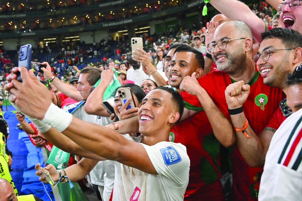 Morocco forward #09 Soufiane Rahimi celebrates with fans after winning in the shootout during the 2026 World Cup round of 32 football match between the Netherlands and Morocco at the Monterrey Stadium. — AFP