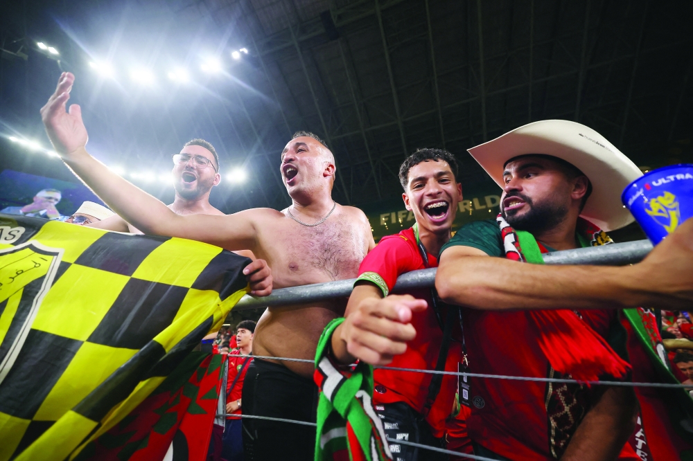 Morocco fans celebrate after the match as Morocco qualify for the Round of 16 stage of the World Cup. — Reuters