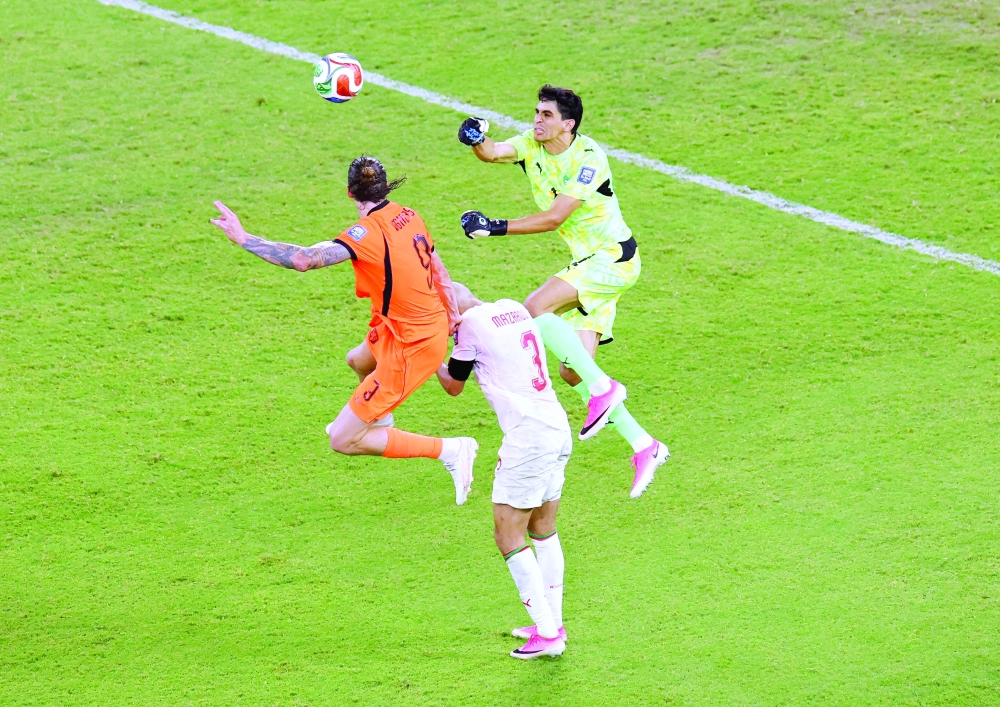 Netherlands' Wout Weghorst in action with Morocco's Yassine Bounou and Noussair Mazraoui. — Reuters