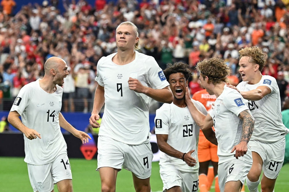 Norway's #09 Haaland (C) celebrates with teammates after second goal. — AFP
