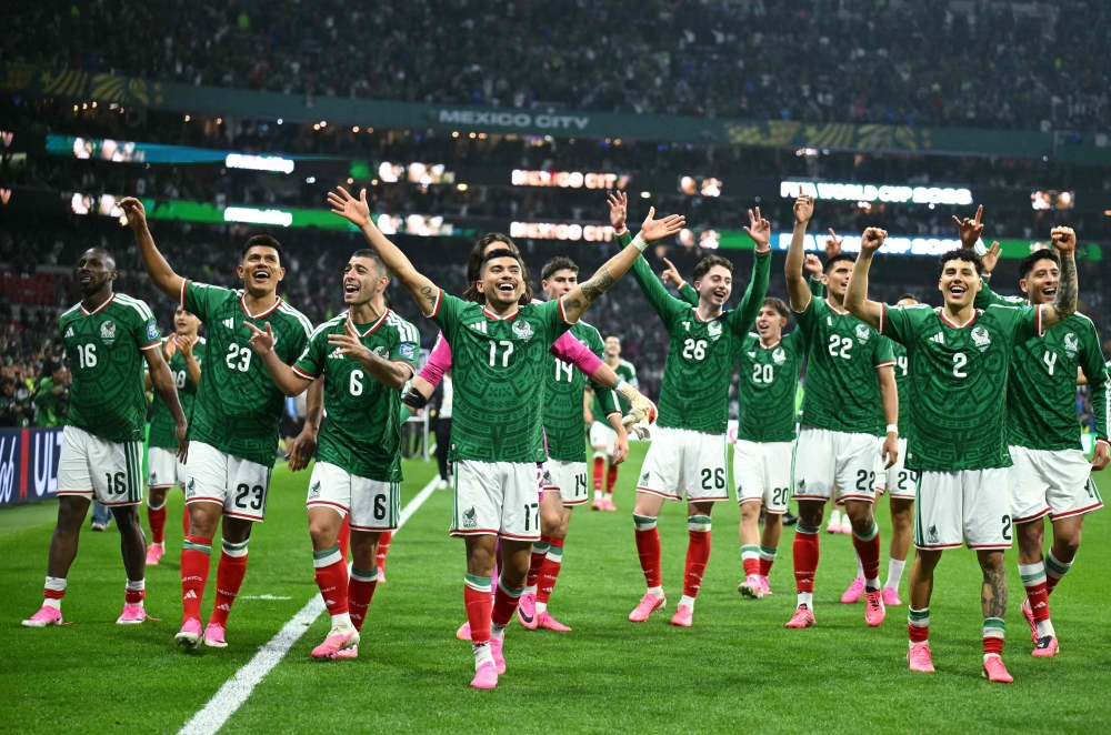 Mexico's players celebrate after the winning. — AFP 