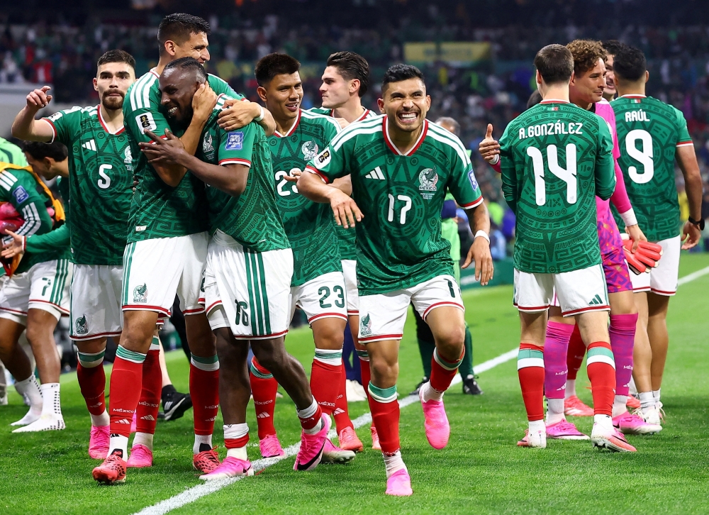 Mexico's players celebrate after the winning. — AFP 