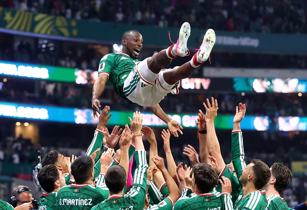  
Mexico's Quinones is thrown in the air in celebration by teammates. — Reuters