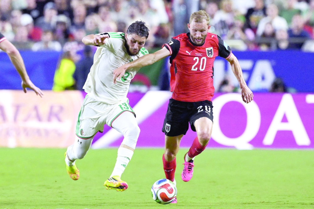 Algeria's defender Jaouen Hadja and Austria's midfielder Konrad Laimer fight for the ball during the 2026 World Cup Group J football match between Algeria and Austria at the Kansas City Stadium. — AFP