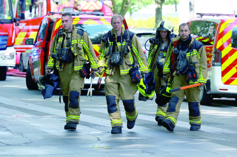 Firefighters work at the site of a fire in a housing building in Antwerp, Belgium. — AFP