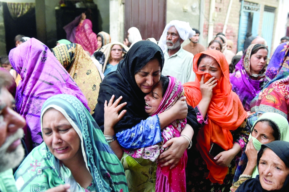 Relatives of the children who reportedly died after a tuition center roof collapsed, mourn in Lahore, Pakistan, June 30, 2026. REUTERS/Murtaza Ali     TPX IMAGES OF THE DAY     