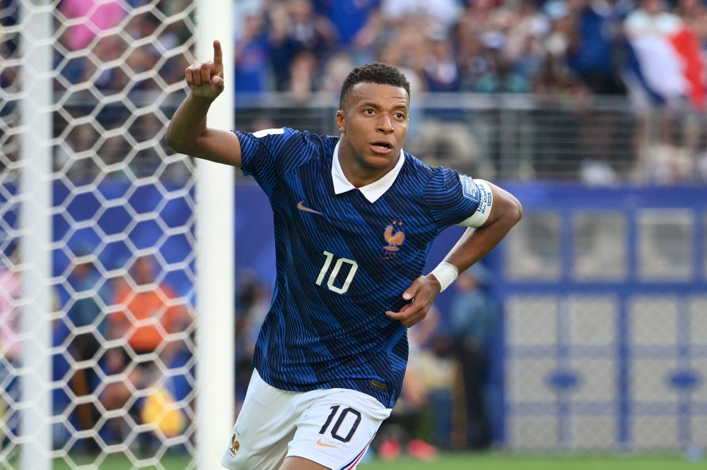 France's forward #10 Kylian Mbappe celebrates scoring his team's third goal 