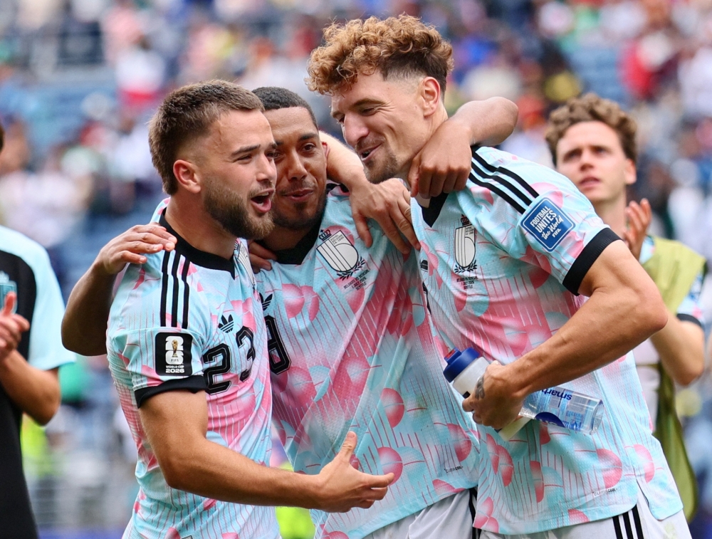  
 Belgium's Raskin, Tielemans and  Meunier celebrate after the match. — Reuters 