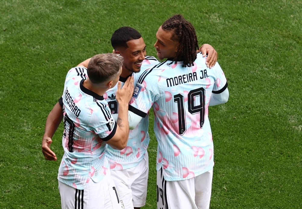  
Belgium's Tielemans celebrates third goal with Trossard and Moreira. — Reuters