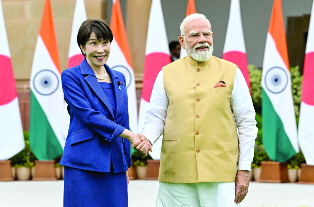 
Narendra Modi (R) shakes hands with Sanae Takaichi in New Delhi on Thursday. — AFP 