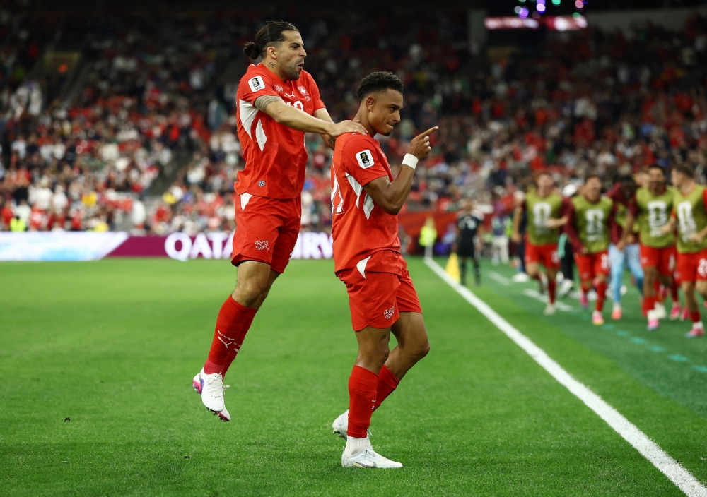  
Switzerland's Ndoye celebrates second goal with Rodriguez. — Reuters 