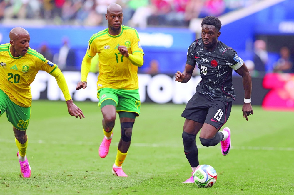 Canada's defender #19 Alphonso Davies runs with the ball. — AFP