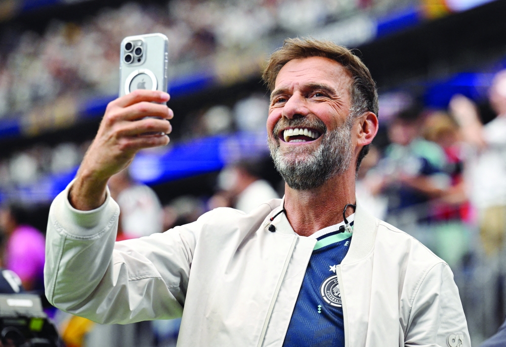 Red Bull's Global Head of Soccer Juergen Klopp takes a photograph inside the stadium after the match. — REUTERS