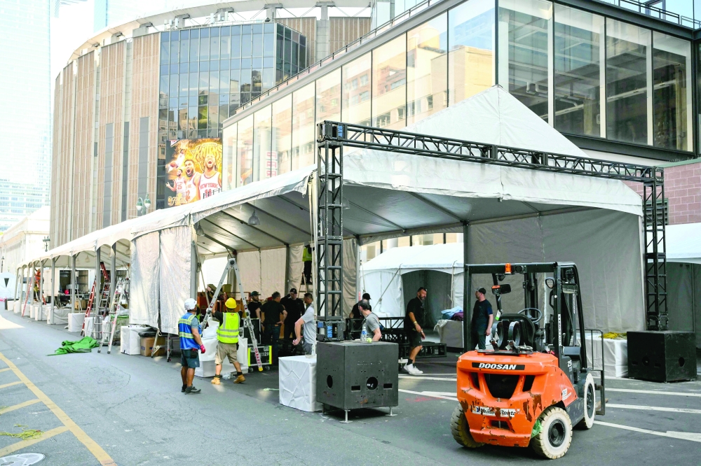 Workers make adjustments to a tent outside Madison Square Garden, the reported venue for the wedding celebrations of pop singer Taylor Swift and pro-athlete Travis Kelce, in New York City. - AFP