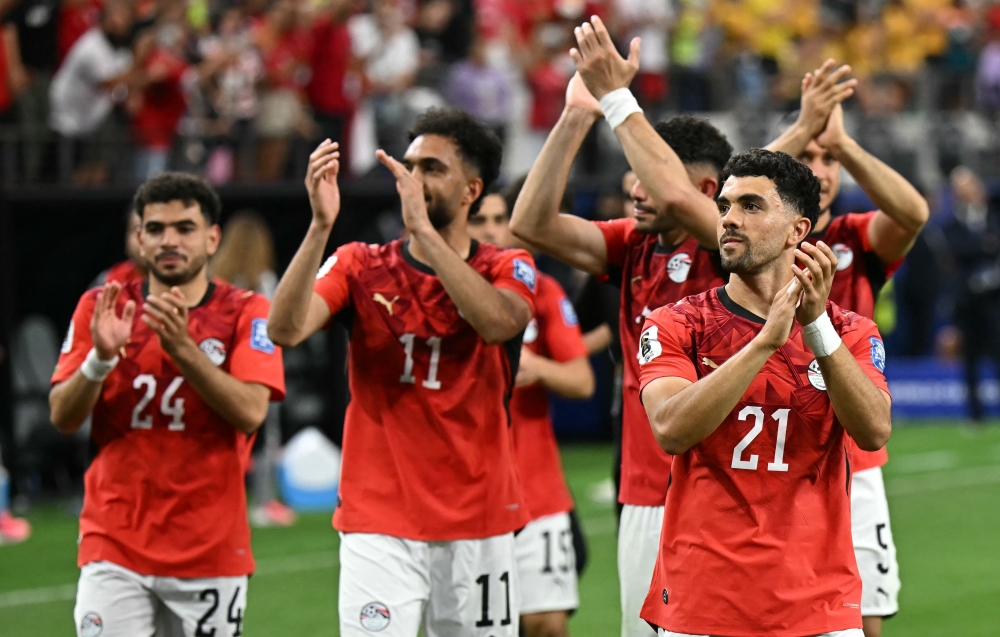 Egypt's  #21 Saber (R) celebrates with teammates. — AFP