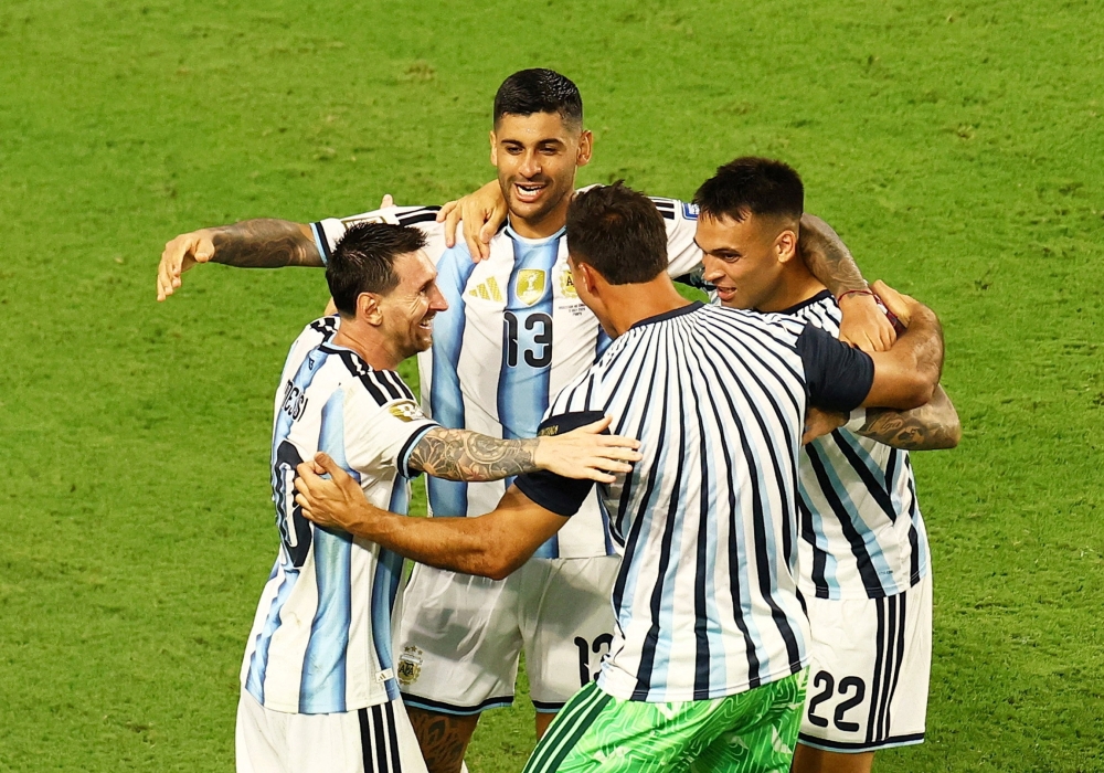  Argentina's Romero celebrates scoring third goal with teammates. — Reuters  