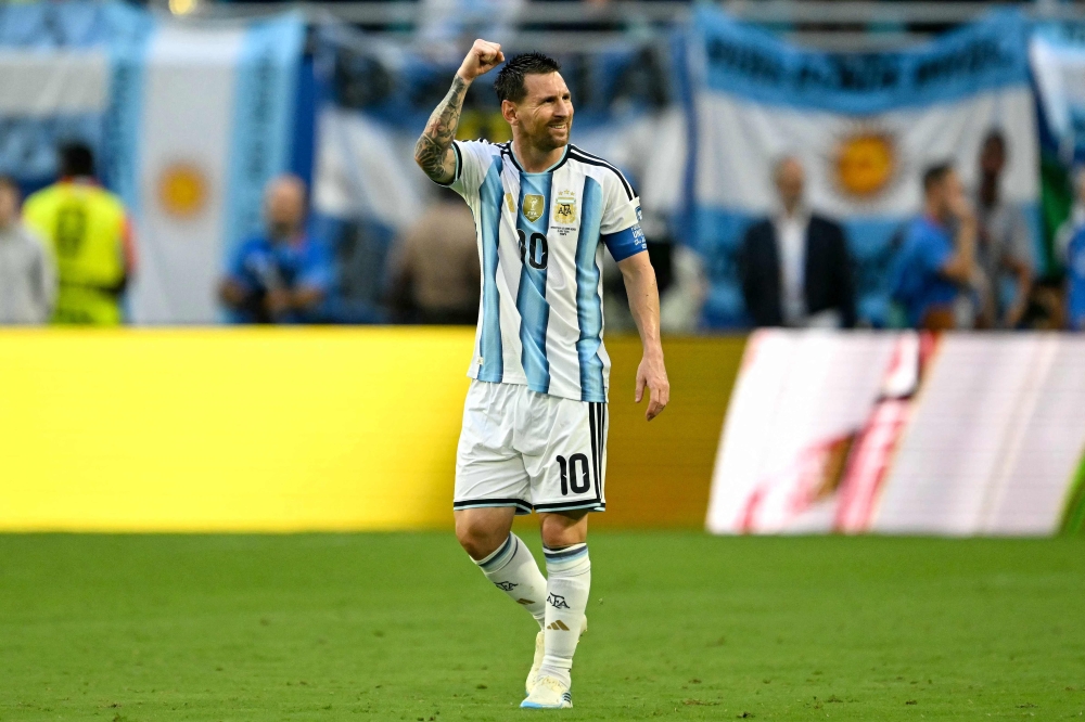 Argentina's  #10 Messi celebrates  first goal. — AFP  