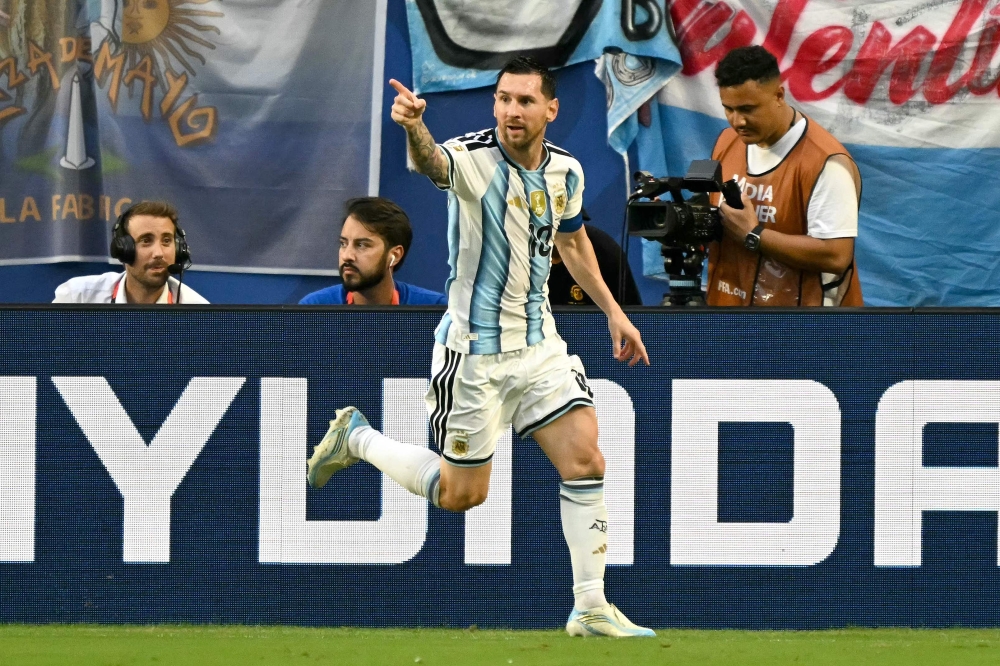 Argentina's  #10 Messi celebrates  first goal. — AFP  