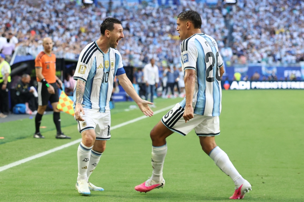 Argentina's #10 Messi celebrates with #26 Molina. — AFP 