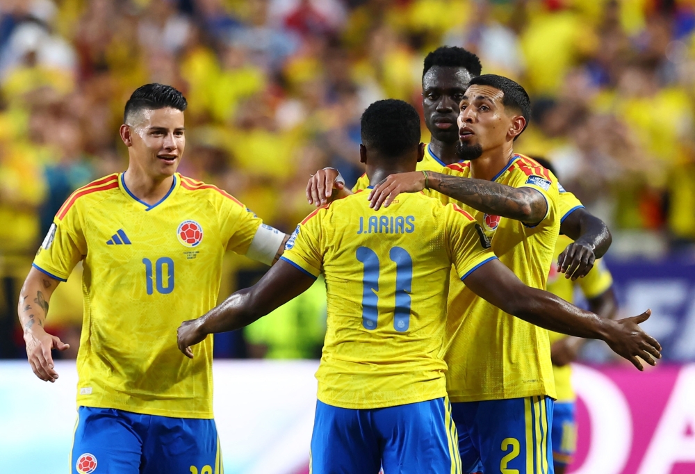  
Colombia's Arias celebrates scoring first goal with Munoz, Sanchez and Rodriguez. — Reuters