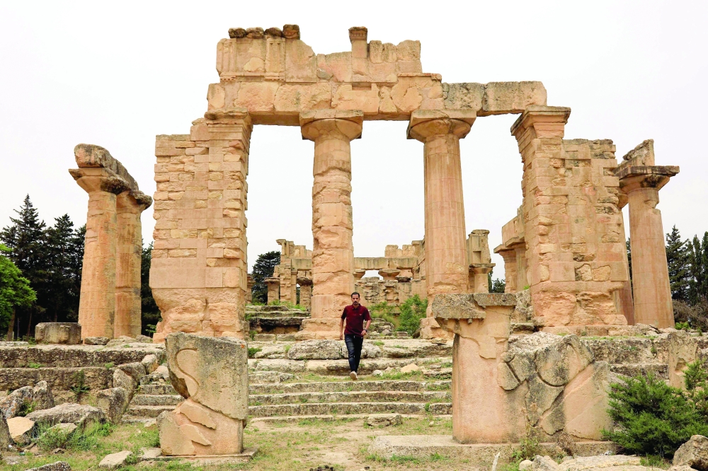 A man walks through the ruins of the Temple of Zeus at the archaeological site of Cyrene. — AFP