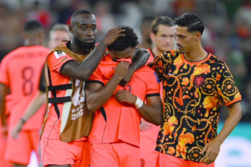  Netherlands' #02 Geertruida, #26 Timber and #14 Reijnders. — AFP
