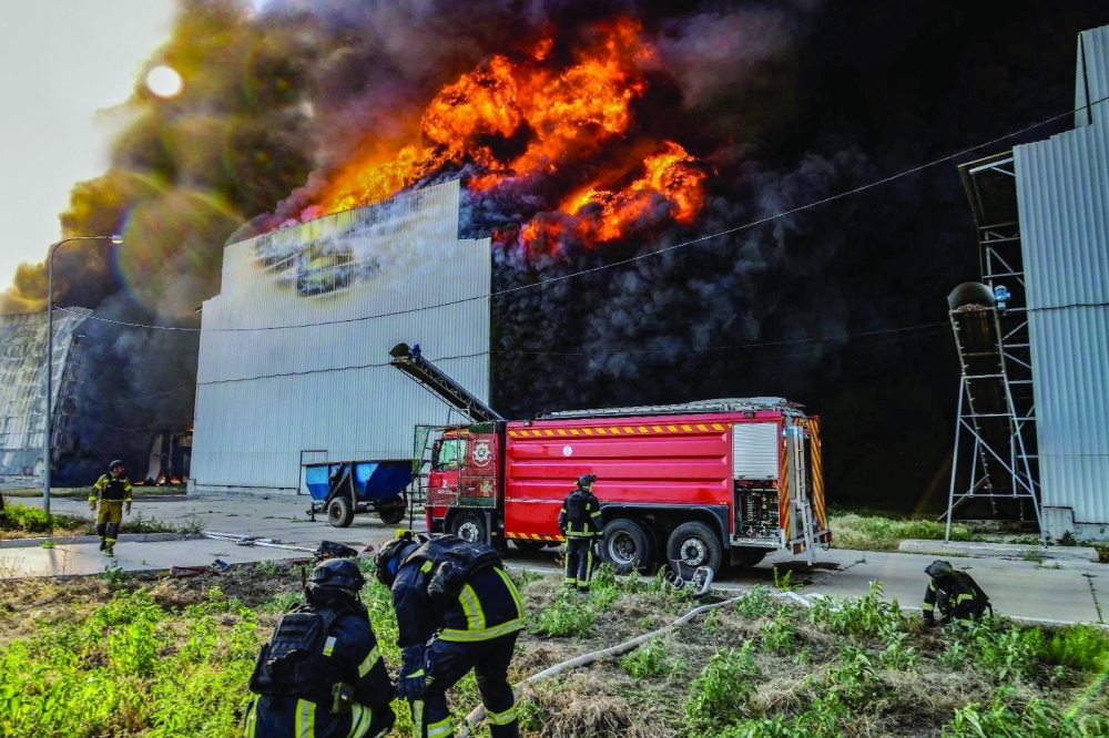 Firefighters work at the site of one of the biggest Ukrainian poultry farms which was hit by a Russian air strike in the town of Chornobaivka. — Reuters