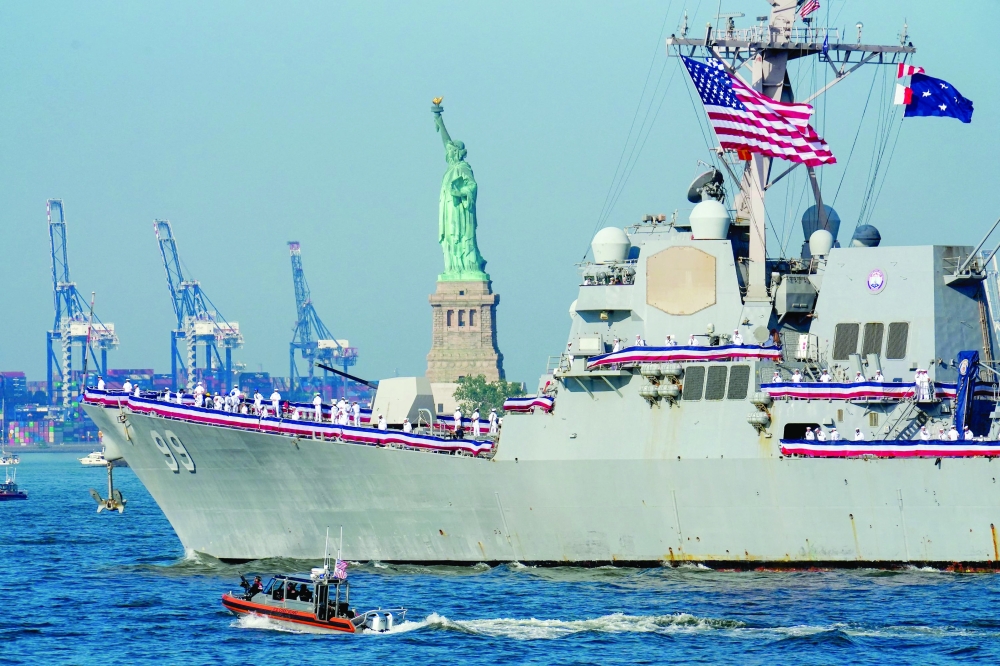 US Navy destroyer USS Farragut (DDG-99) sails by the Statue of Liberty ahead of the "Sail250" ships gathering event, in New York. — AFP
