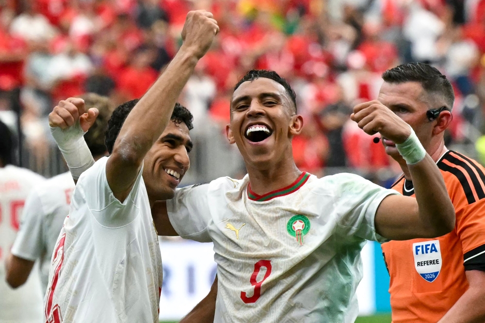 Morocco's defender #02 Achraf Hakimi and Morocco's forward #09 Soufiane Rahimi celebrate after winning  