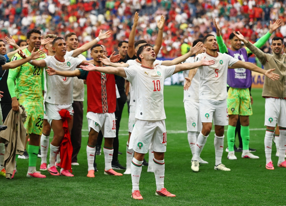  
Morocco's Brahim Diaz and teammates celebrate after the match  