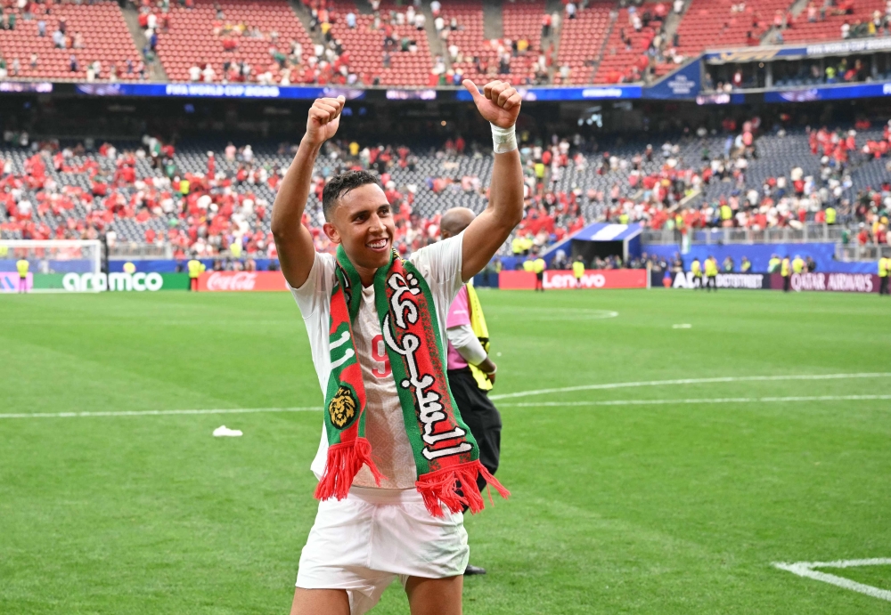 Morocco's forward #09 Soufiane Rahimi celebrates after winning  
