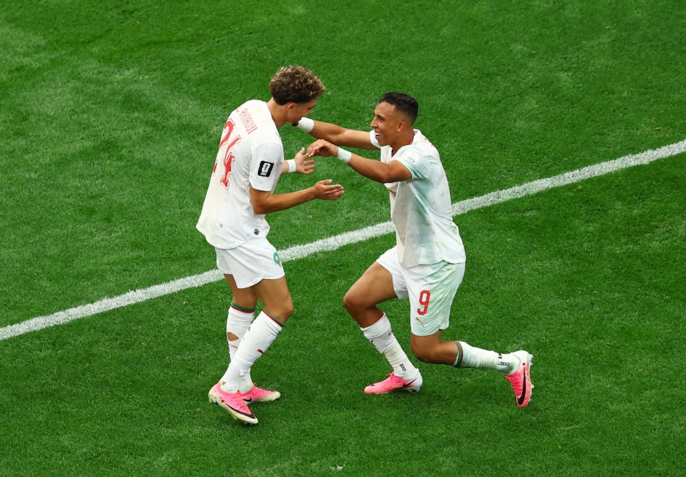  
Morocco's Soufiane Rahimi celebrates scoring their third goal with Neil El Aynaoui  