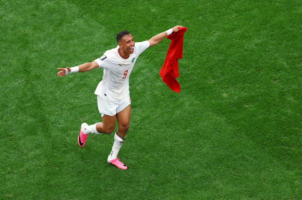  
Morocco's Soufiane Rahimi celebrates after the match as Morocco qualify for the quarter final stage of the World Cup 