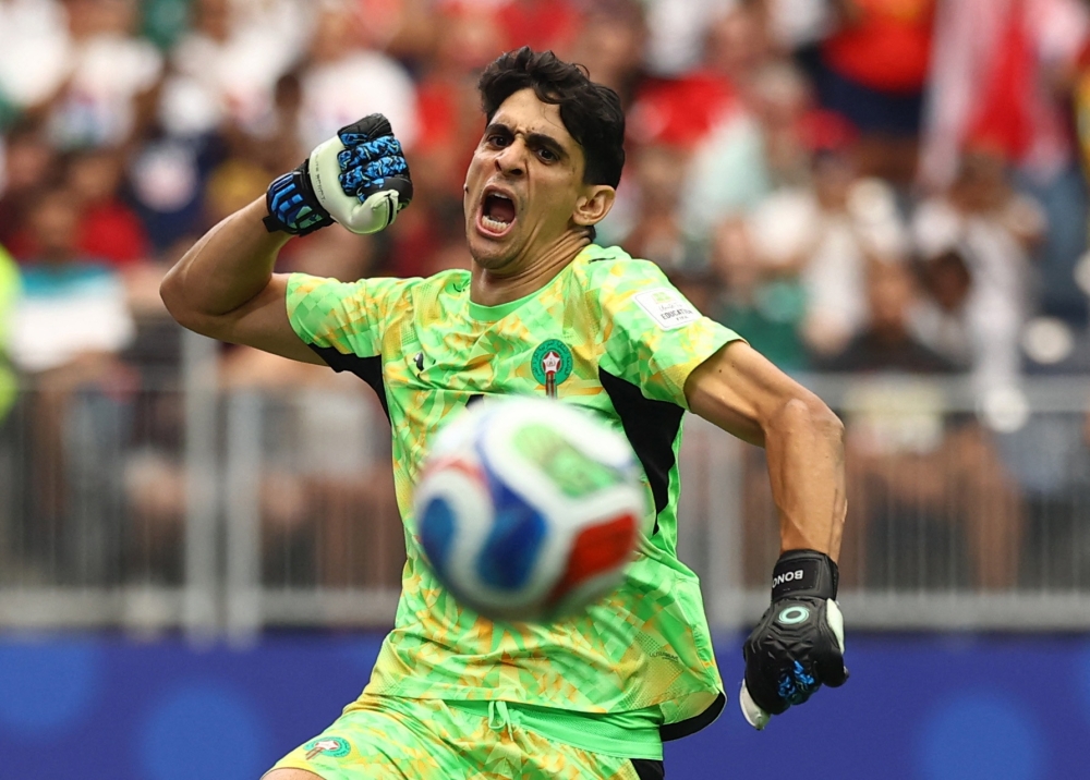  
Morocco's Yassine Bounou celebrates their third goal, scored by Soufiane Rahimi 