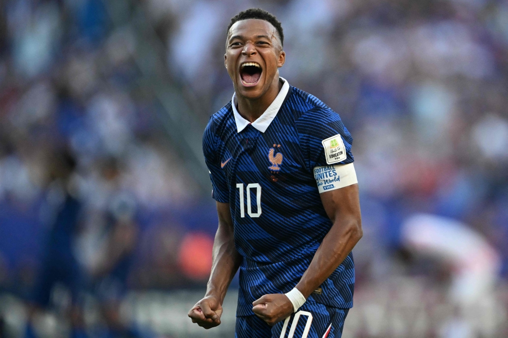TOPSHOT - France's forward #10 Kylian Mbappe celebrates after winning  